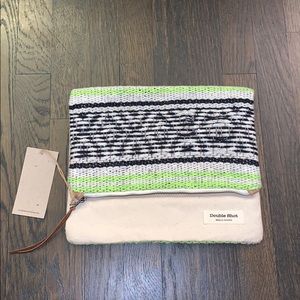 Fold over clutch with leather accents. Brand new!!